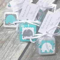 teal white and grey baby shower favors made with soap elephant themed made with soap. A personalized tag tied with ribbon