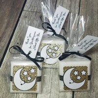 moon and star baby shower favor soaps with black and gold accents a tag with personalized lettering tied with a ribbon