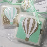 Baby shower favor soaps hot air balloons mint green and gold tied with a personalized tag on a ribbon