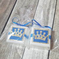blue and gold little prince crown favors made with paper design on white soaps and tied with ribbon