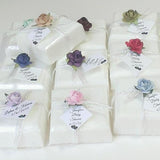 sweet sixteen favors made with soap topped with paper flowers and a custom tag