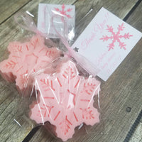 snowflake soaps wrapped as favors with ribbon and personalized tags in pink